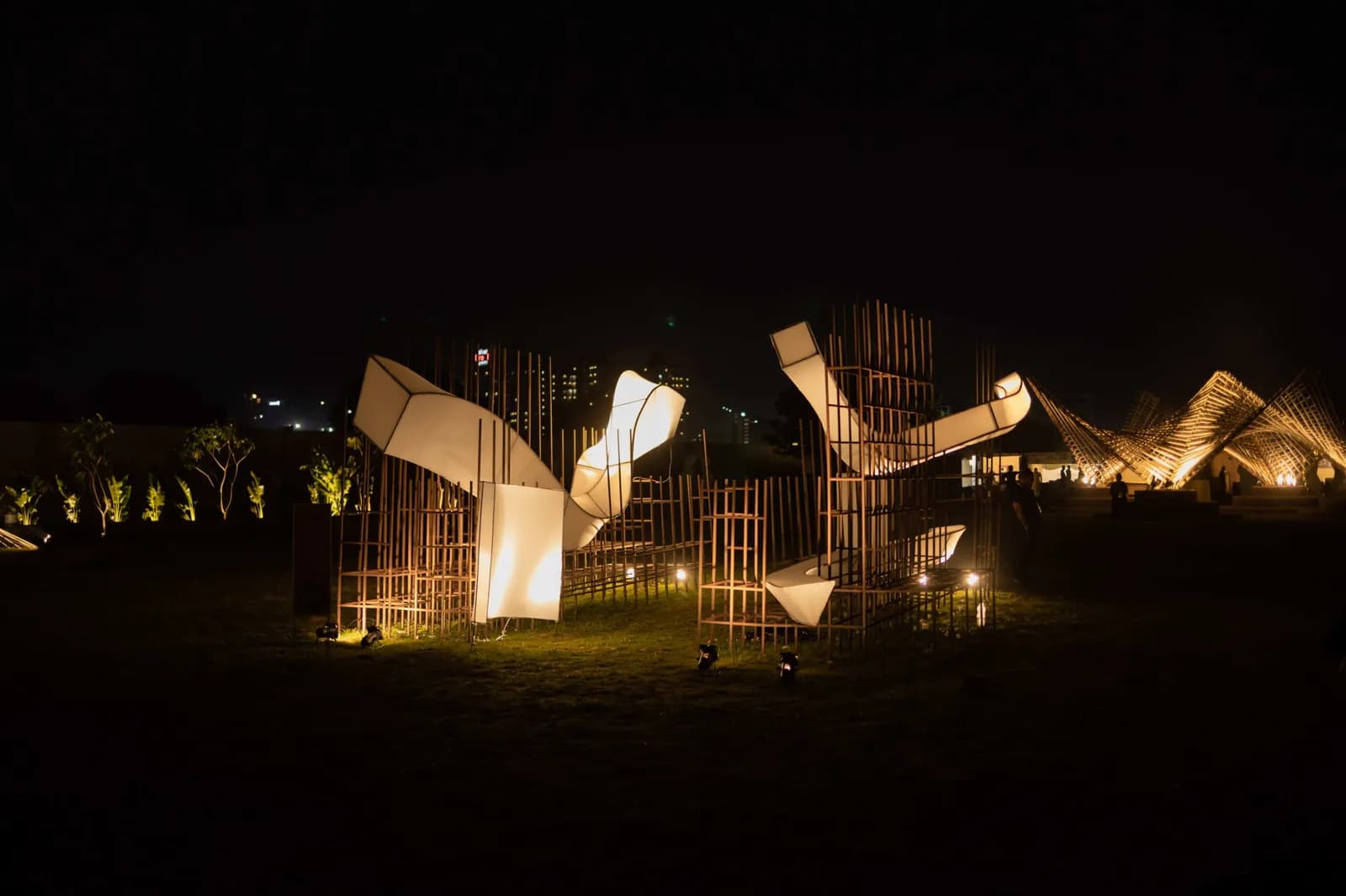 A lit installation standing at the edge of the ground