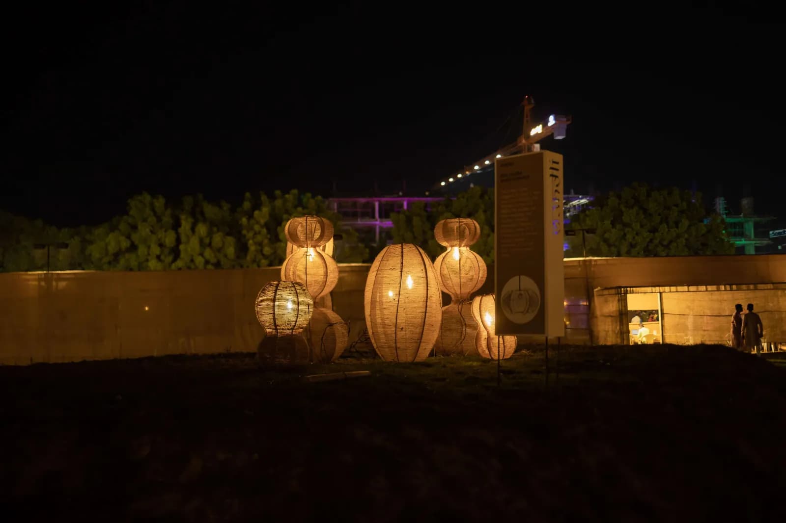 Round lanterns glowing along the boundary wall